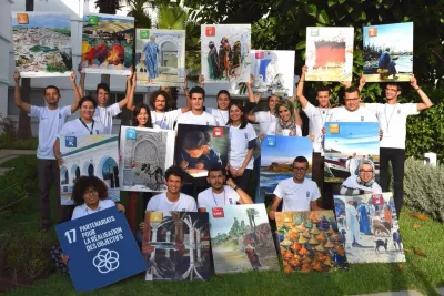 Young people hold signs representing the Sustainable Development Goals.