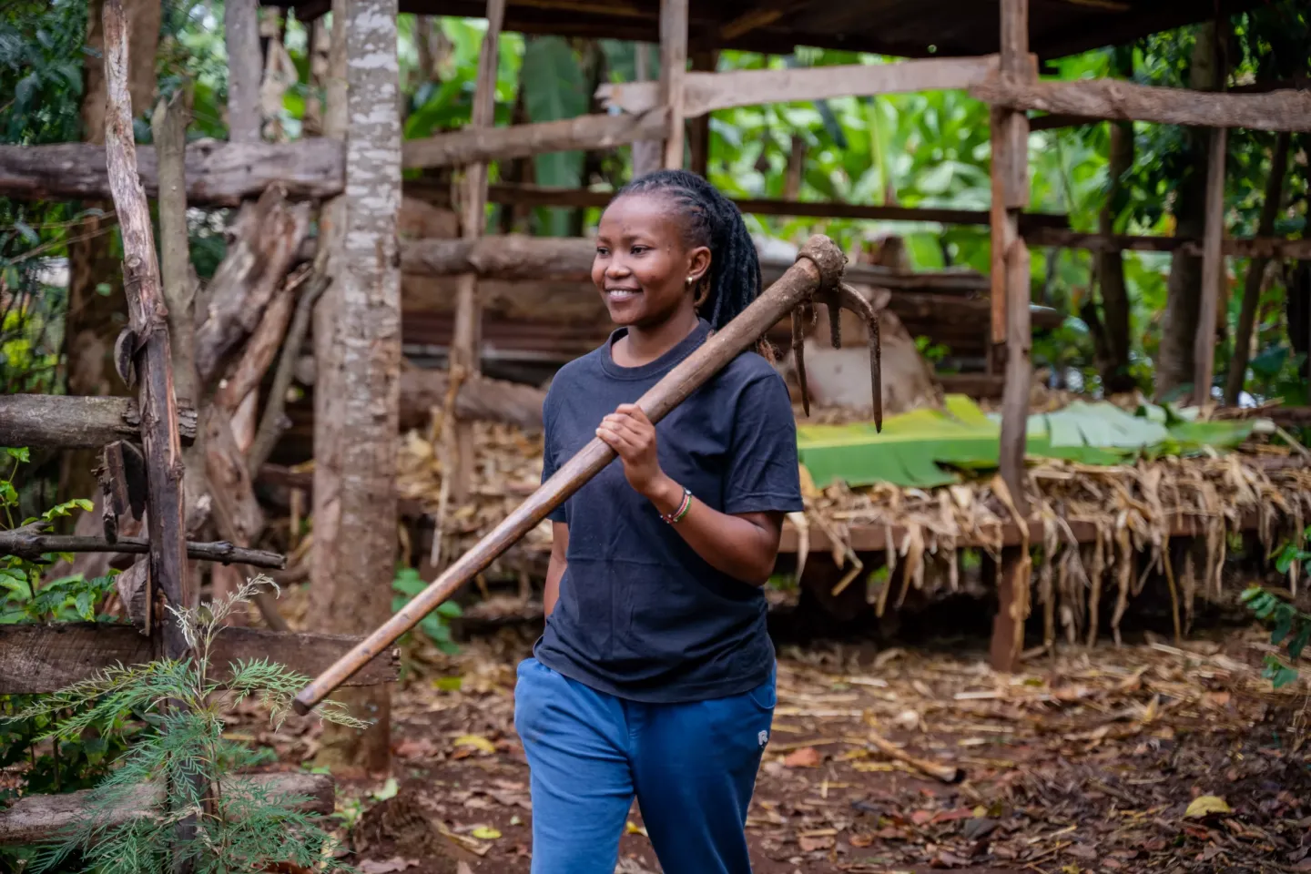 Grace Nyawira is heading towards her field to nurture and care for the plants. 