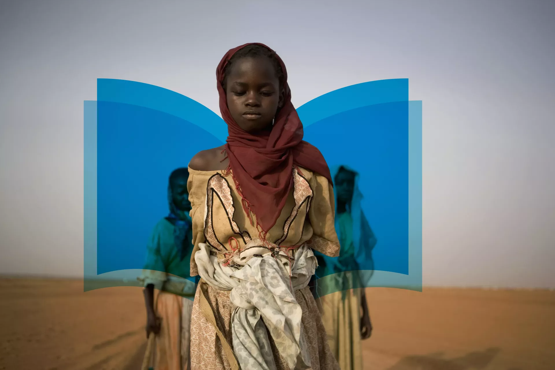 A girl walks home from school in Sudan.