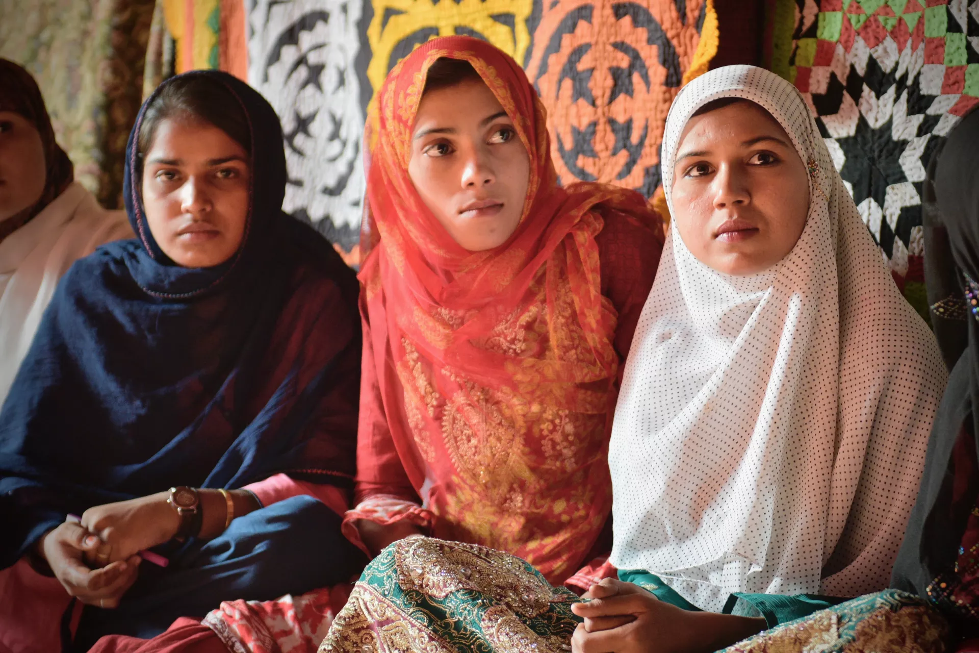 3 young girls from Pakistan looking at the camera