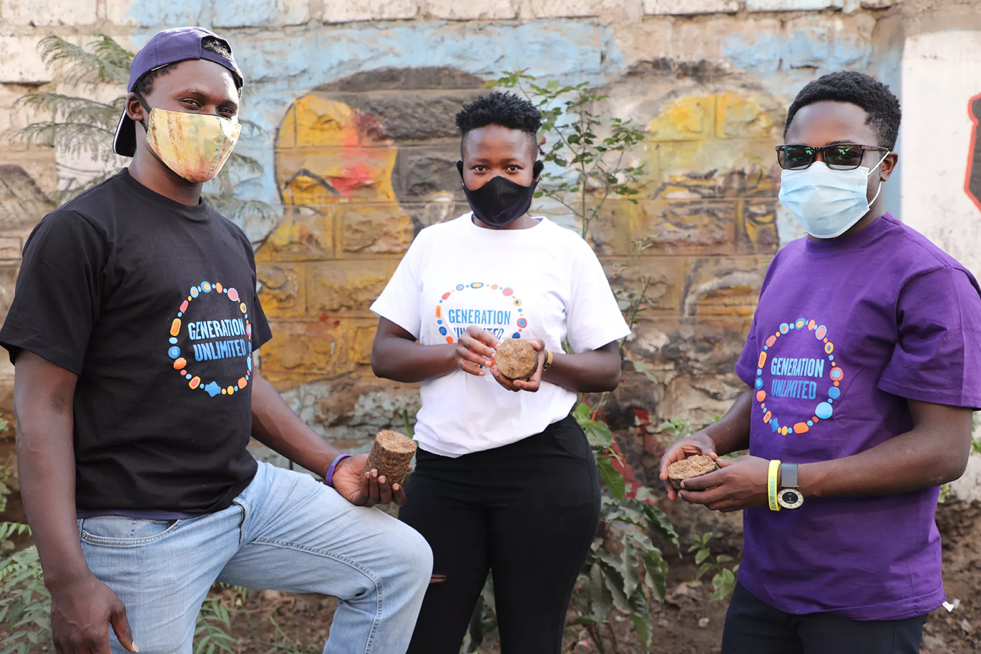 Three young Kenyan GenU-ers with GenU T-shirts pose for a picture
