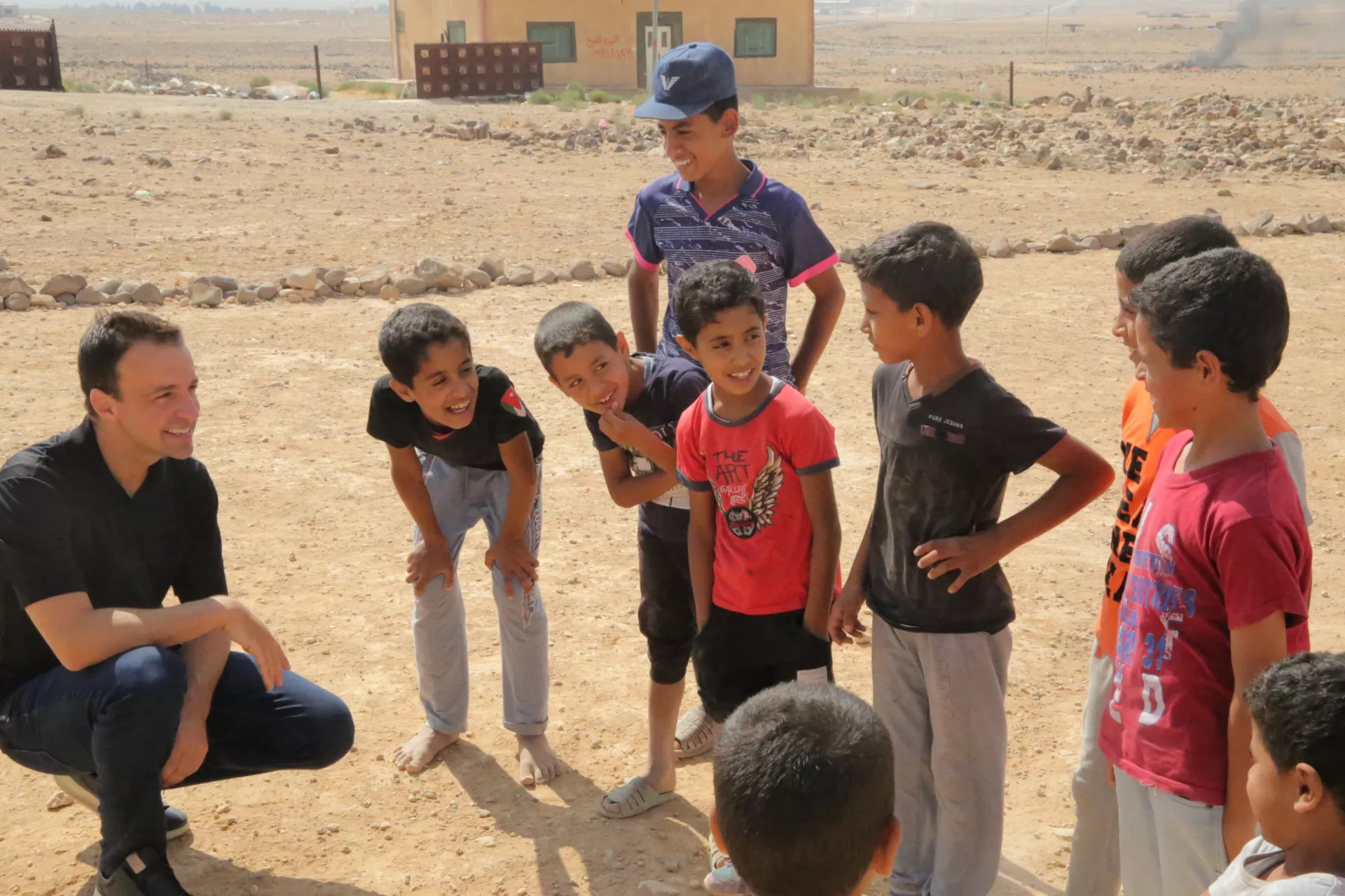 Kevin Frey witha group of kids in Mafraq, Jordan from back in 2018