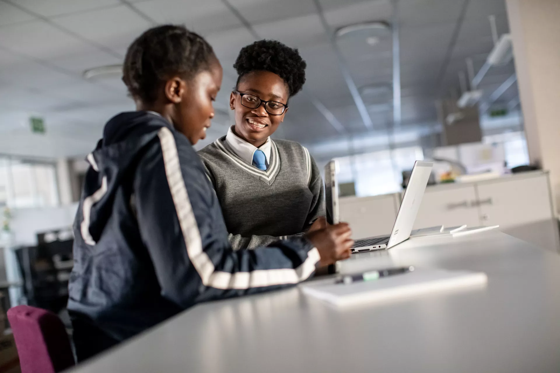 Sebabatso Nchephe (right), 18, and her best friend, Bianca Ndlovu, 19, hone presentation preparation skills they learned during an internship at Roche Pty Ltd, a leading healthcare company, at the company's offices in Sandton, South Africa