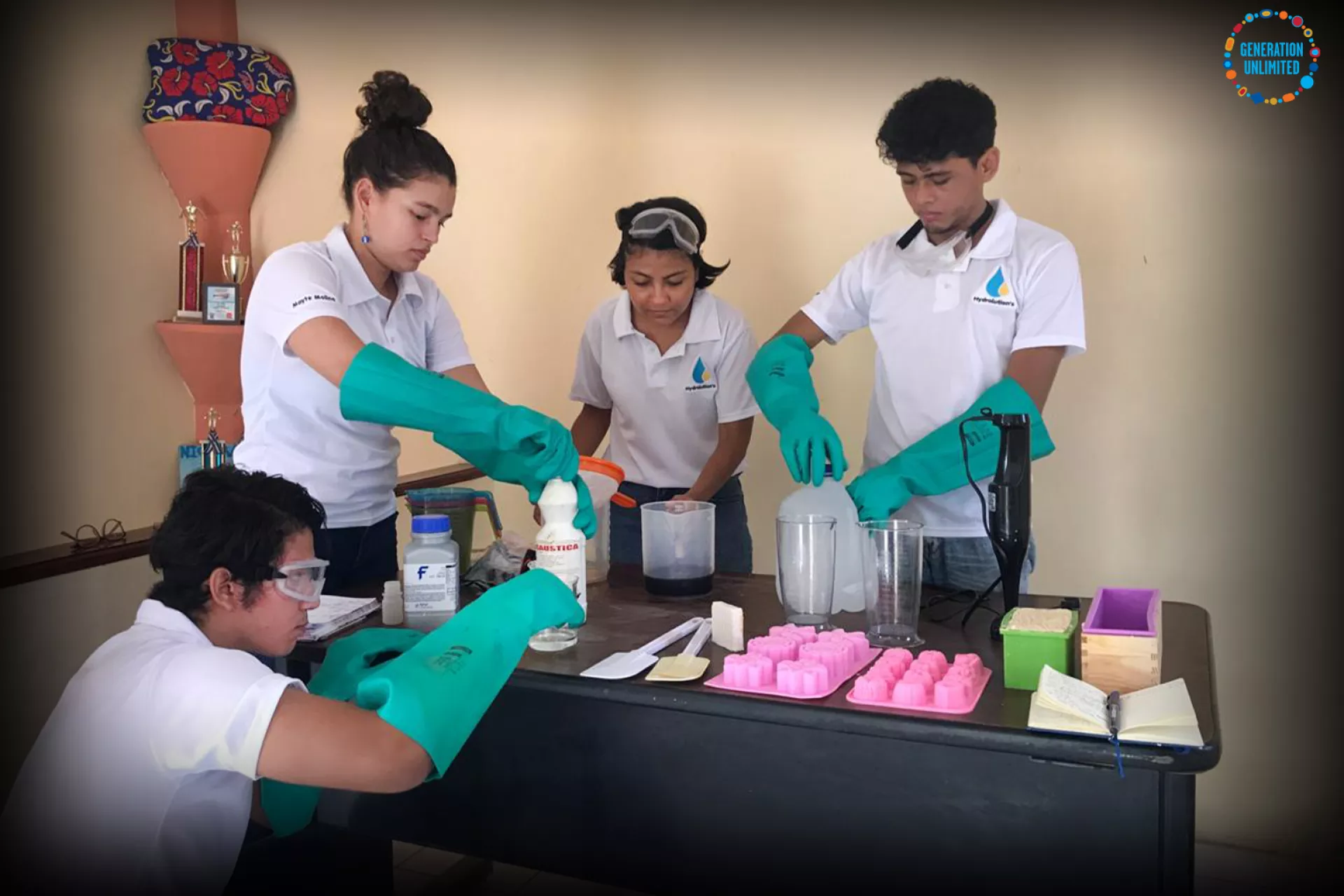 The four youngsters behind Hydrolution operating vials and equipment to produce the soap