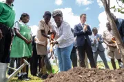 Prime Minister Mia Mottley and a young participant take part in a tree planting activity at the Green Rising launch in Barbados, alongside former GenU CEO, Kevin Frey.
