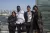 Four members of the Generation Unlimited Board pose for a photo in front of the United Nations in New York City.
