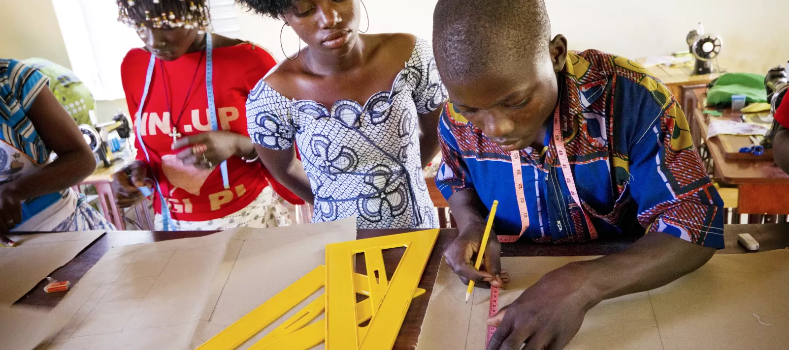 A student measures shapes at a class in Burkina Faso.