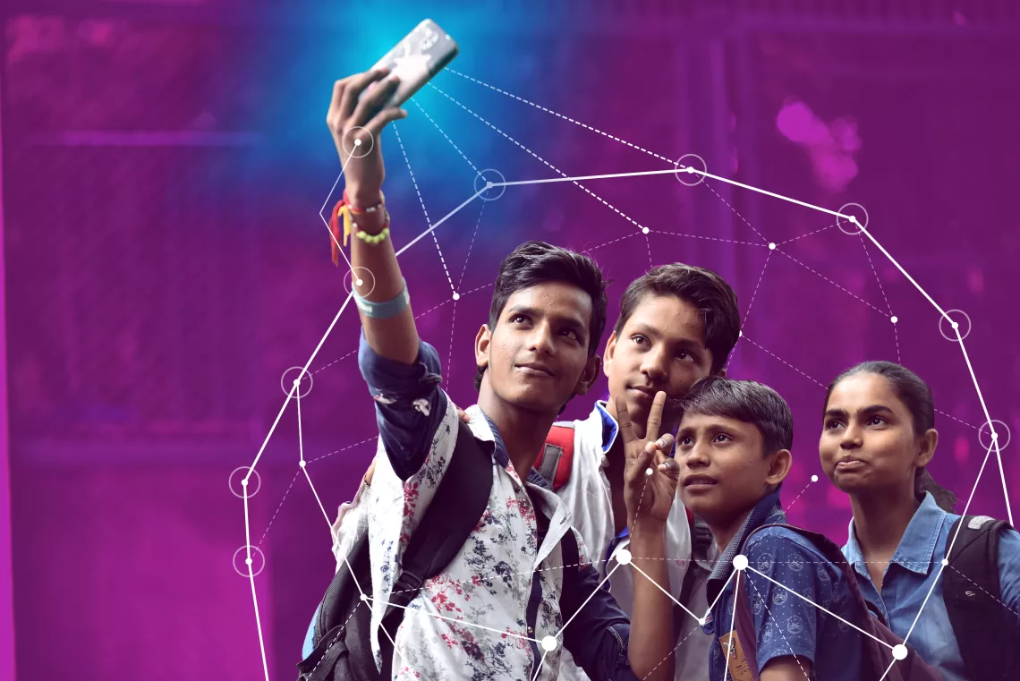 Four young people pose for a selfie in India.