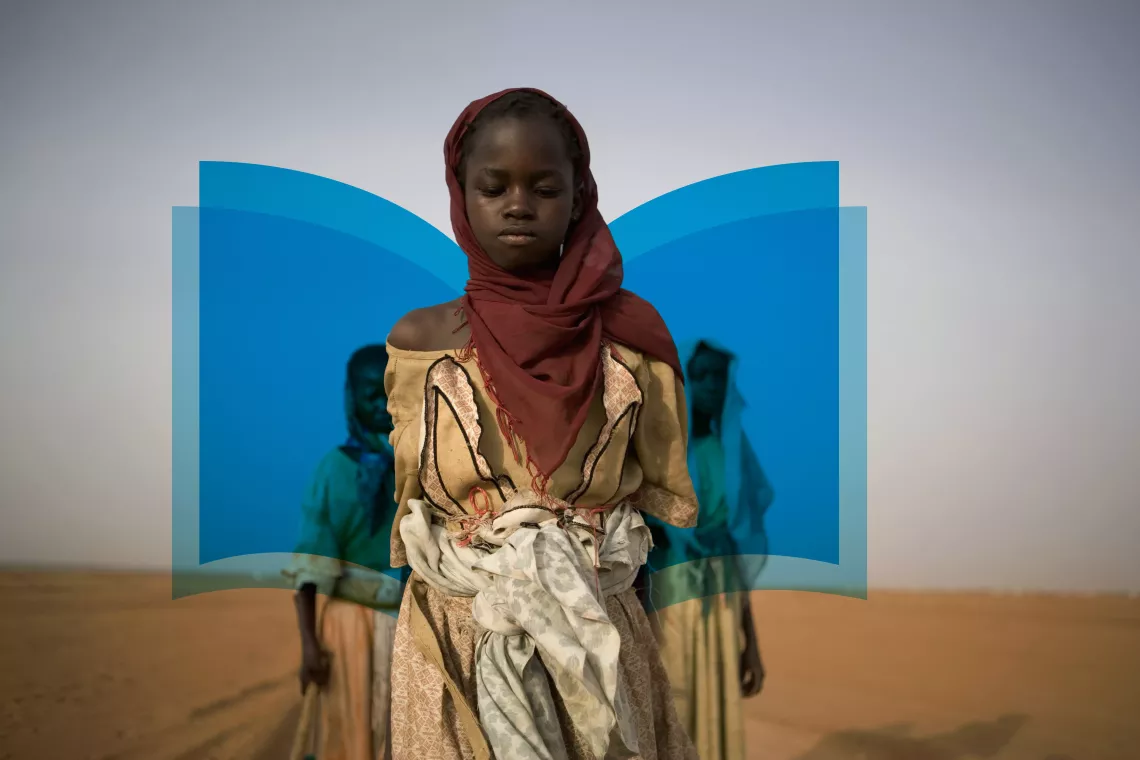 A girl walks home from school in Sudan.