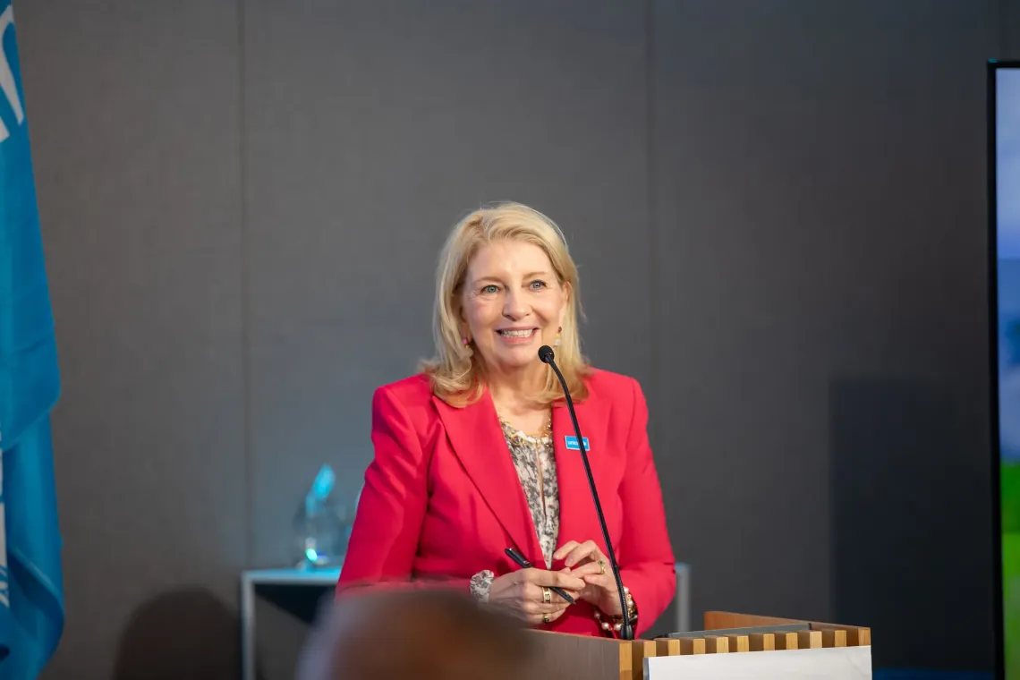 UNICEF Executive Director Catherine Russell speaking at a lectern on stage during a event.