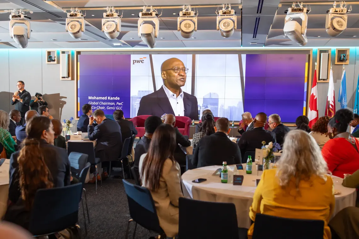 Mohamed Kande, in a video address, shown on screne to seated attendees around round tables at the Generation Unlimited Global Leadership Council event.