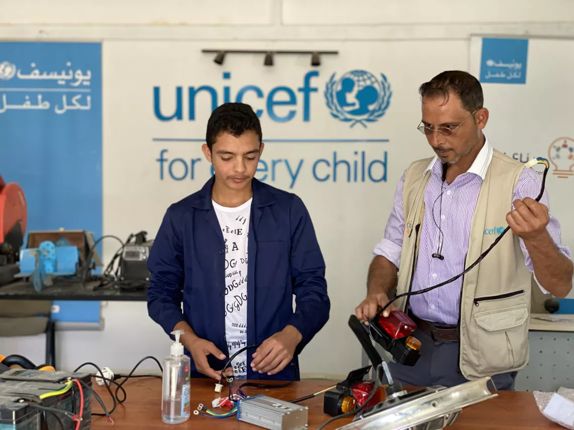 Youth demonstrating his innovation to UNICEF staff