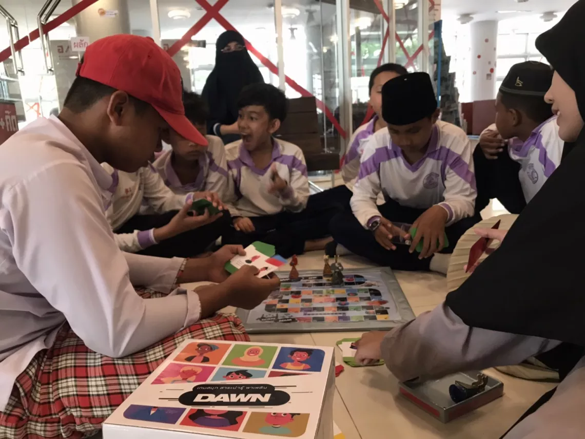 a group of kids playing the Dawn Board Game