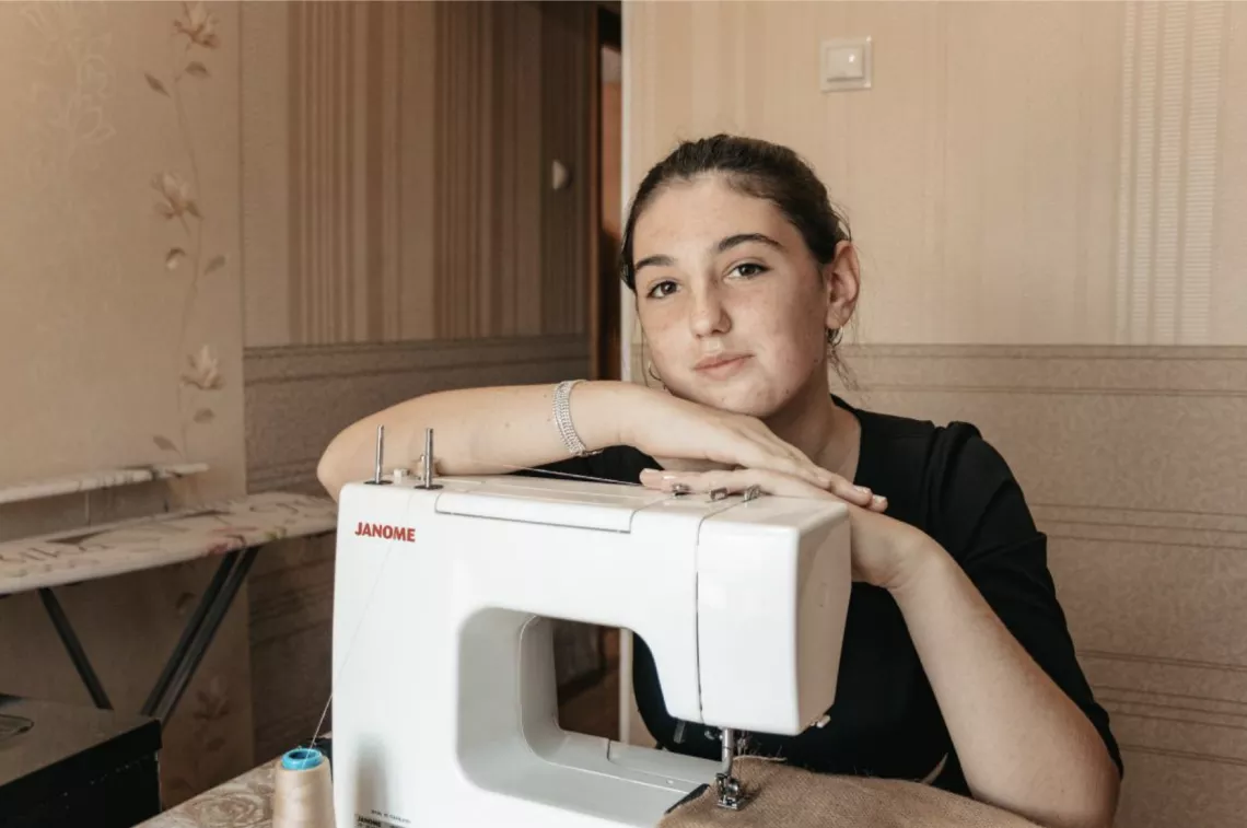 Daria sewing an eco bag on an electric sewing machine