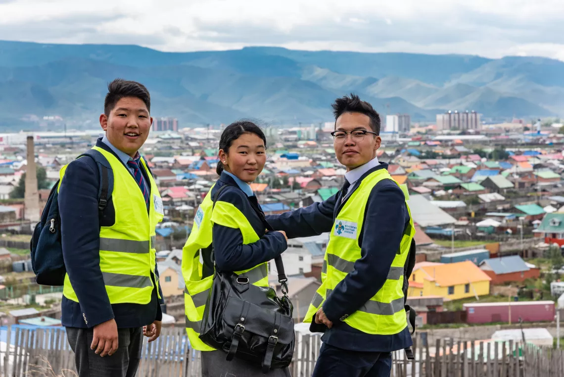 Three adolescents collecting air pollution data in the outskirts of Ulaanbaatar, Mongolia