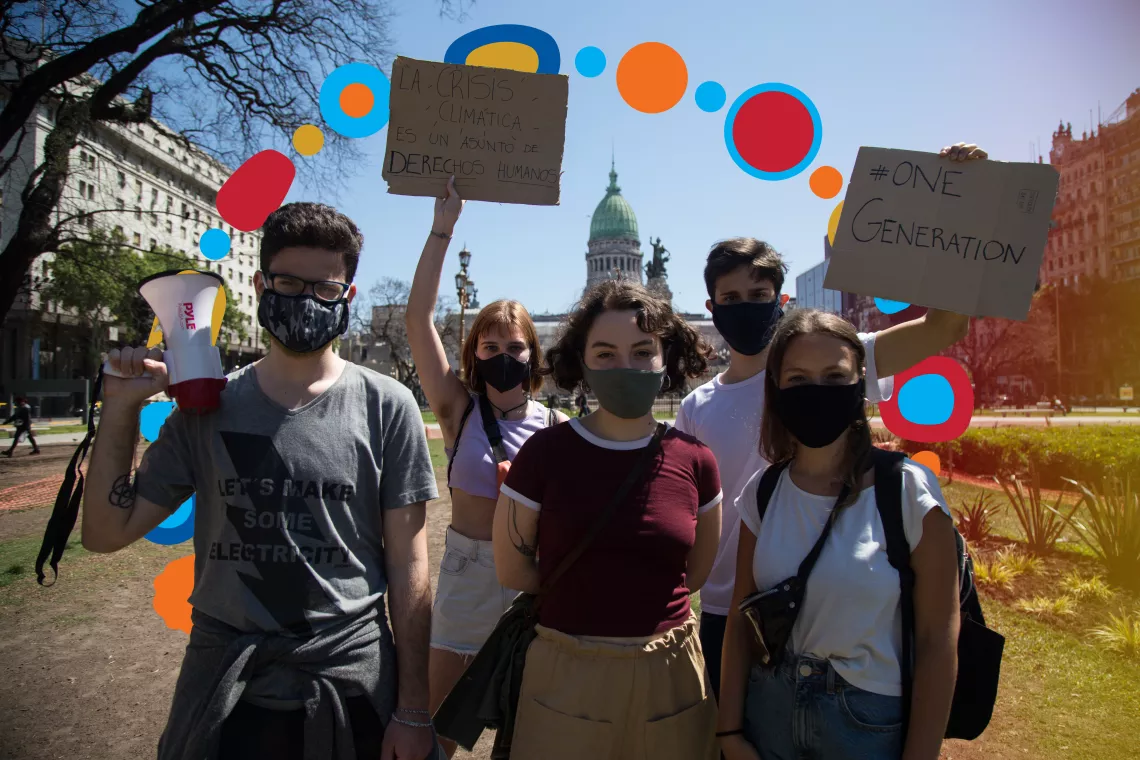 A group of Argentinian youngsters protesting against climate change, holding up signs and a megaphone
