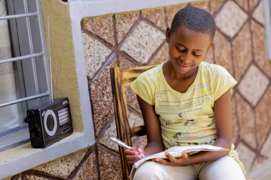 Umuhoza Dative, 11, Rwanda, studies at home due to coronavirus-related school closures, listening to her Primary 6 lessons on the radio every day.