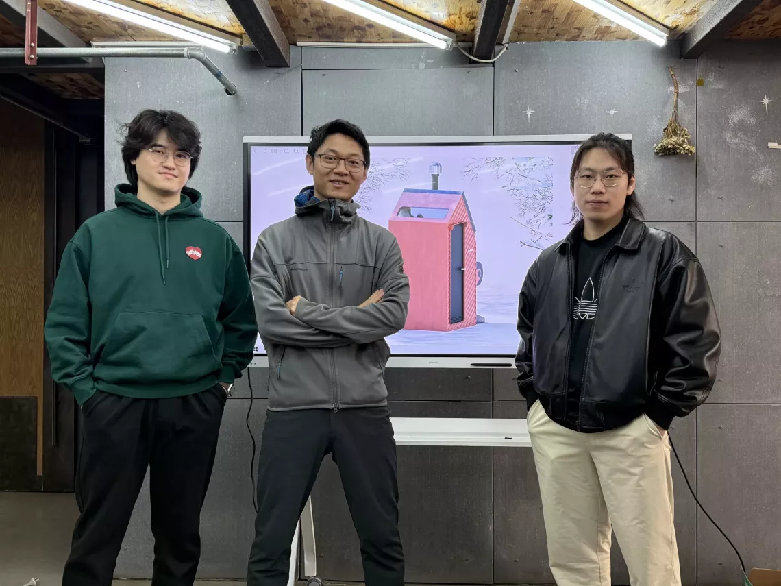 Members of Pureco pose for a photo in front of a screen displaying a prototype of their solution.