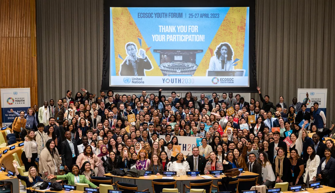 Group photo at the ECOSOC Youth Forum. Screen on the wall says Thank you for your participation
