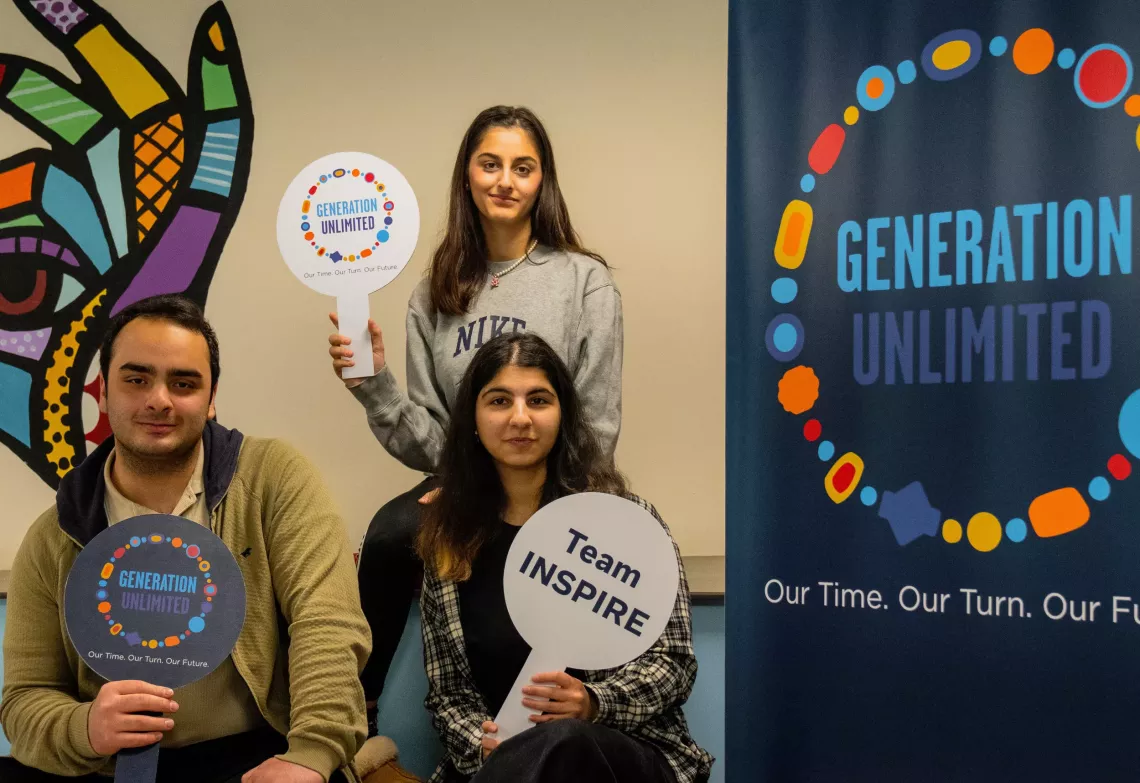 photo of the team forom turkiye next to a banner of generation unlimited