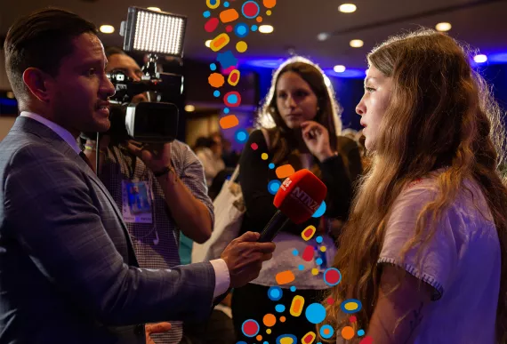 Young girl being interviewed by a journalist