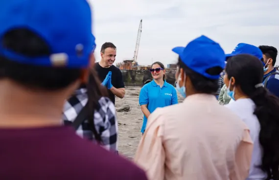 Kevin Frey takes part in a beach clean-up activity with young people in India as part of YuWaah, GenU India's platform for youth engagement and opportunity.