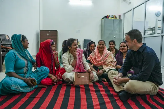 Kevin discussing with a group of young women in India